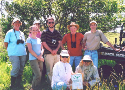 Members of the Iowa City Bird Club present the official Important Bird Area sign to two of the owners of Indiangrass Hills, Judy Felder and Sandy Rhodes, during the summer of 2005.